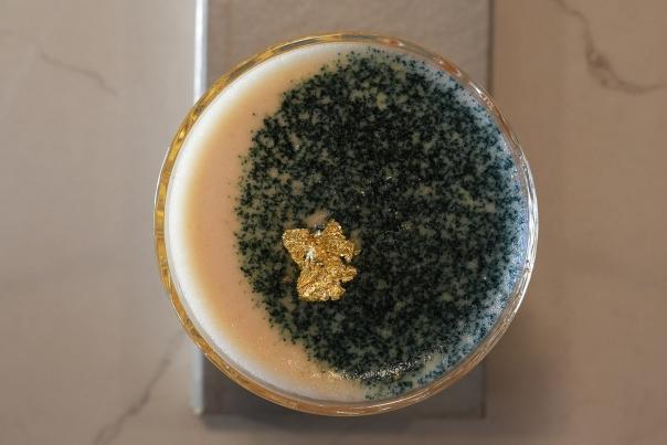 A glass from a birds-eye view, with garnish in the shape of a moon