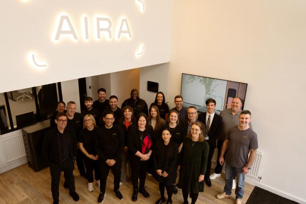 AIRA Team gather under AIRA sign in new NW tech hub