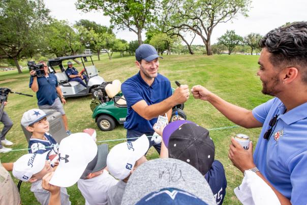 Tony Romo signing autographs at the Invited Celebrity Classic