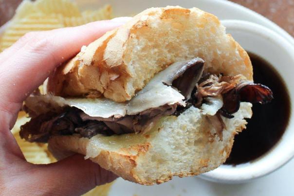 Person holding a french dip sandwich from Jason's Deli in Irving, TX
