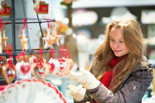woman shopping for ornaments at a holiday market