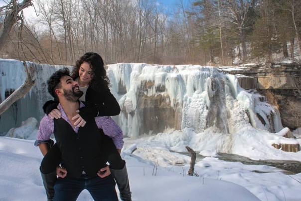 Couple in front of a frozen waterfall