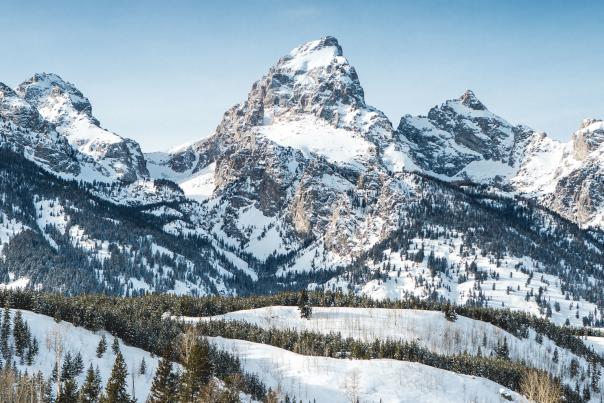 Grand Tetons with snow and blue skies