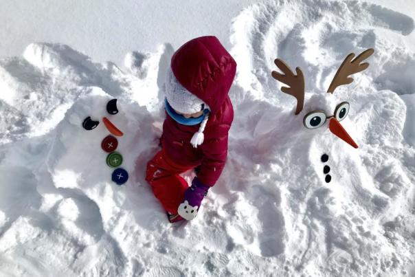 Child building snowmen