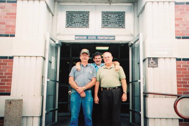 MSP staff members Charles Ferrell, Thomas Rose, and Mark Schreiber stand at the front of the Missouri State Penitentiary on the last day of clean-up after the facility closed in 2004.