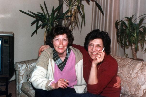 Ava Gardner and her friend Nahid sitting together on a couch