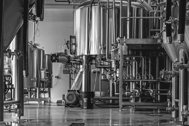 Black & white photos of the Hatchet Brewing facility floor