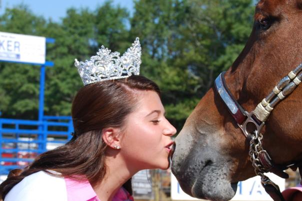 The annual tradition of Miss Benson kissing the Best in Show Mule at Mule Days in Benson, NC.