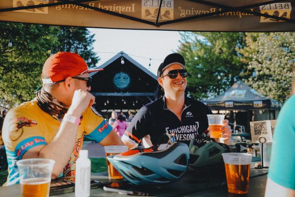 Bicyclists drinking beer at a table