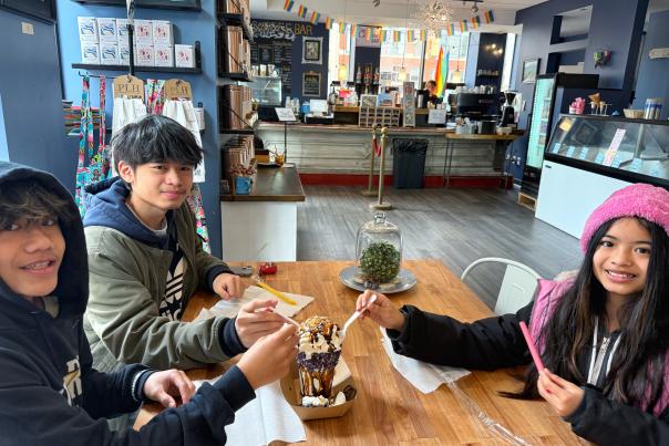 Three kids share a monster milkshake at Cherri's Chocol'Art in Downtown Kalamazoo.