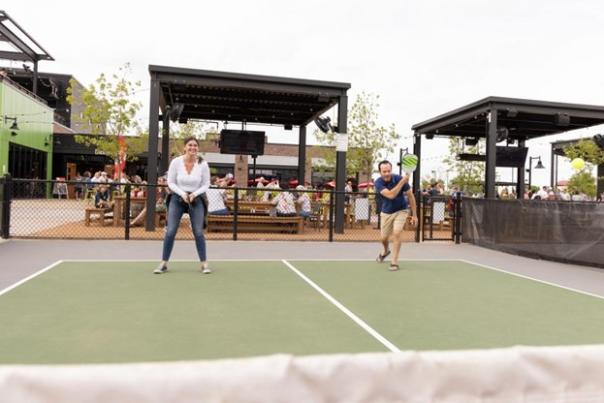 Two people play game on a tennis court