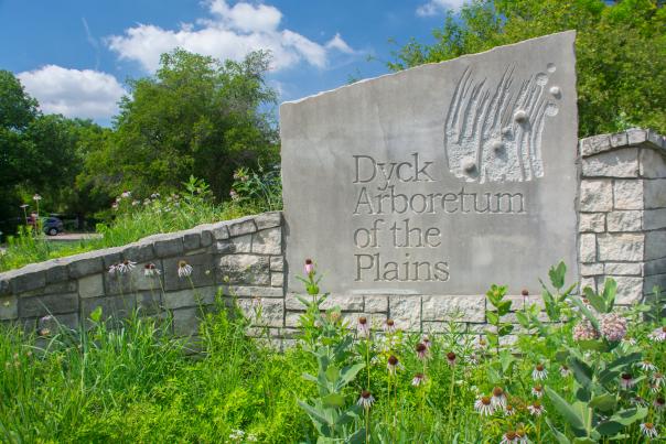 stone sign that reads "Dyck Arboretum of the Plains"