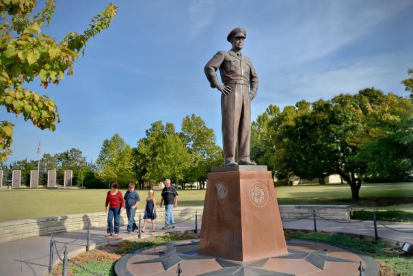 Family walks around a Statue of Dwight D. Eisenhower at the Presidential Museum in Abilene