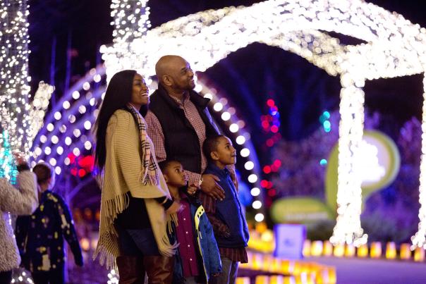 Family stands by Christmas light display in Wichita