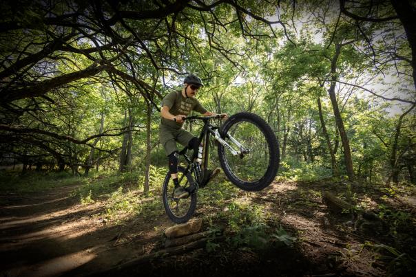 Person rides a bike on a dirt trail in Shawnee Mission Park