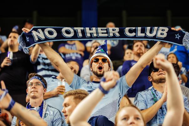 Man holding Sporting KC scarf
