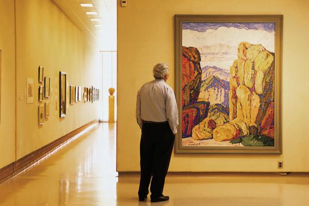 Man observes a painting at Birger Sandzen Gallery in Lindsborg
