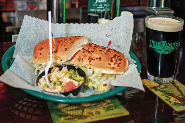 sub sandwich in basket and glass of beer