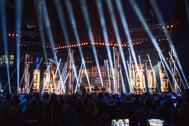 Canadian Country Music Awards stage with concert lighting, live audience, and “Fans’ Choice Award” display at packed country music event
