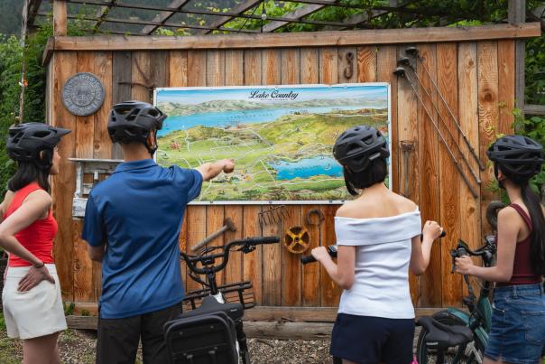 Family with Bikes Viewing Lake Country Map