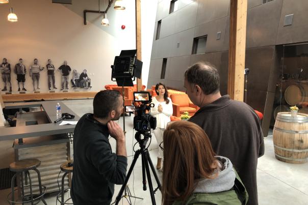 Behind the scenes photo of Jillian Harris filming with Tourism Kelowna