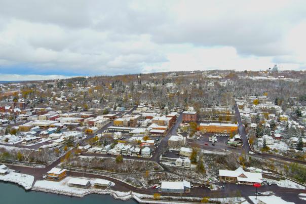aerial of a snowy small hillside town