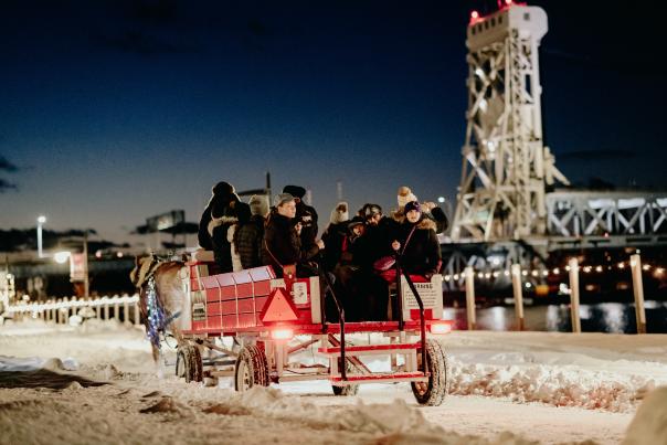 Horse-Drawn Carriage with Portage Lake Lift Bridge in the Background at night