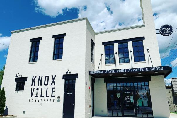 The white exterior of the Knoxville apparel and branded goods store shines bright in the summer sun.