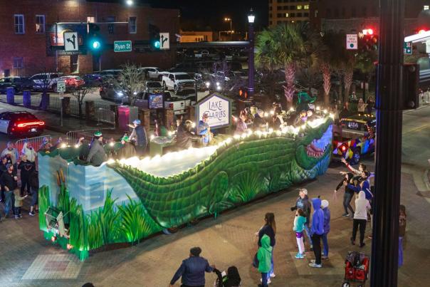 giant alligator float parades through downtown lake charles during Merchants' parade