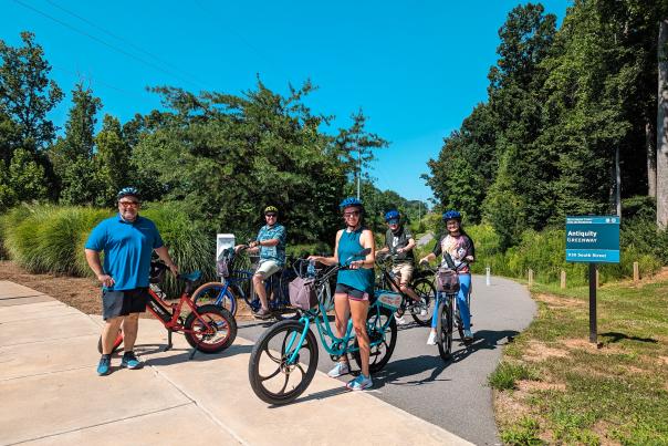 Family In A Park With Pedego Electric Bikes In Lake Norman