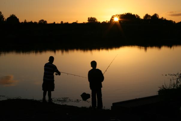 Silhouttes of boys fishing.