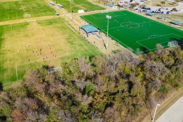 Grass soccer field next to turf soccer field.