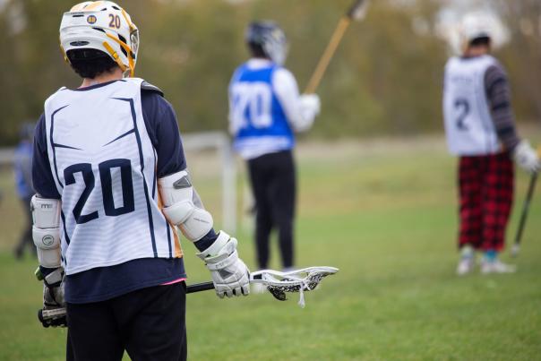 Lacrosse players on the field
