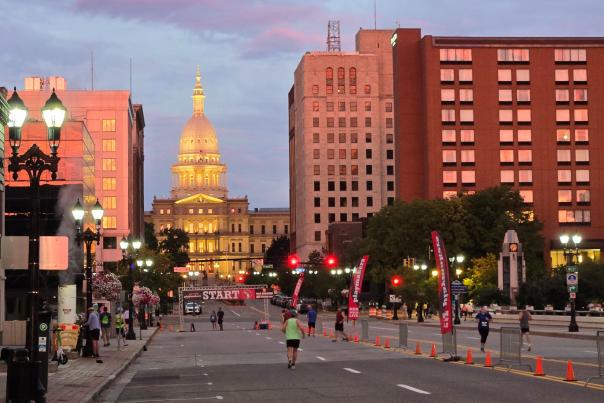 Michigan State Capitol Building in the downtown Lansing with runners starting to line up for the race