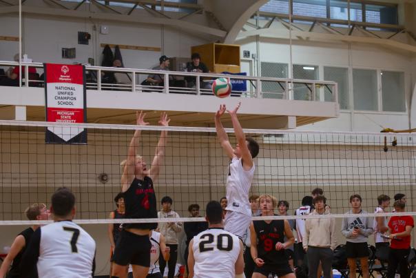 Person trying to hit a volleyball over a net