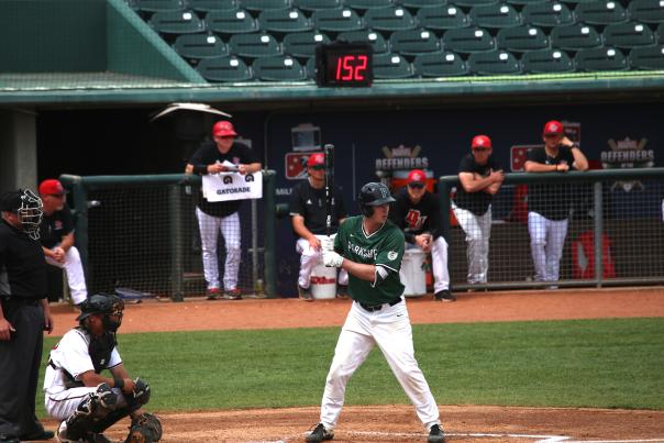 Batter standing on home plate, waiting for the pitch
