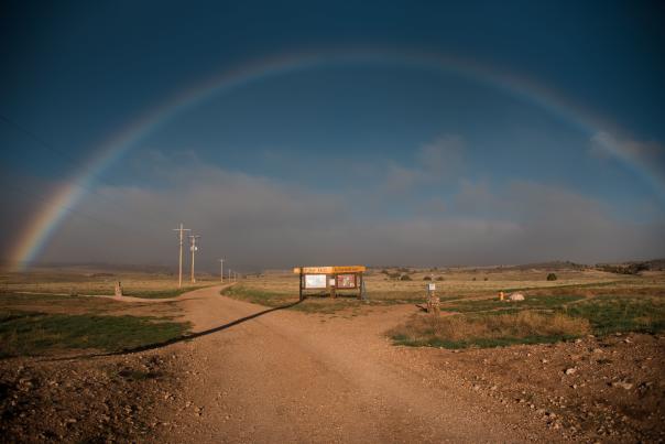 bright rainbow and dirt road