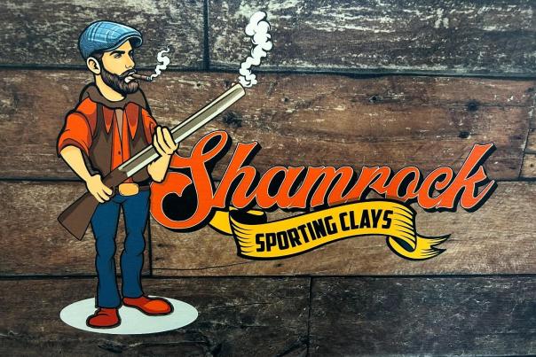 The logo for Shamrock Sporting Clays features a bearded man holding a shotgun and smoking a cigar.