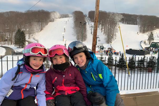 Happy kids on a family ski trip at Seven Springs