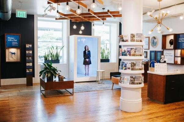 Interior of the Lexington Visitors Center featuring the holobox, plants, brochures, and resources.