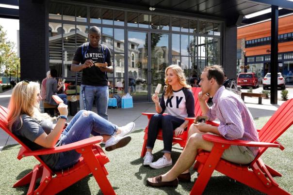 Group of friends enjoying Steel City Pops popsicles outside at The Summit.