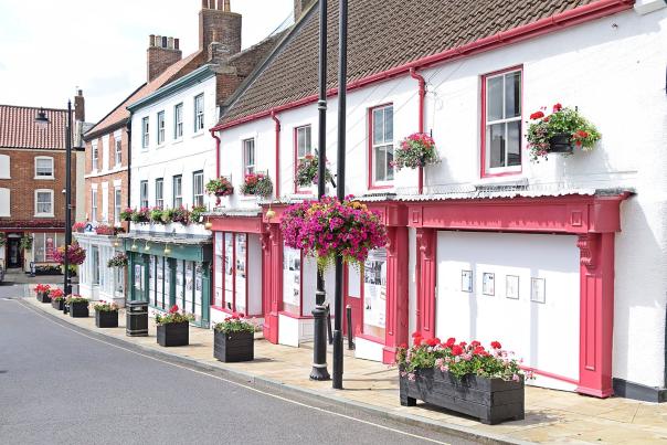 A row of quaint shopfronts in Caistor in the Lincolnshire Wolds with a road in front