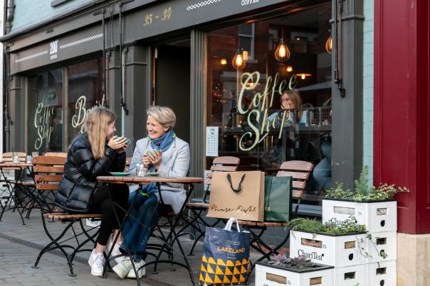 People sitting outside a coffee shop in Cornhill Quarter in Lincoln