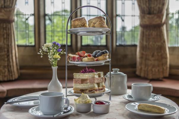 An afternoon tea displayed inside a lavish room.