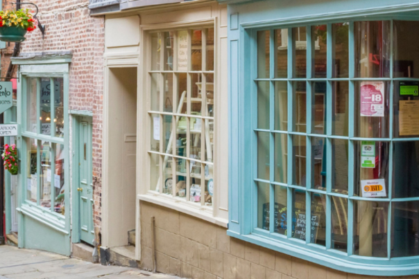 Colourful storefronts against a narrowand steep street.