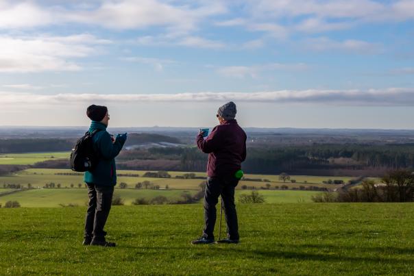A couple taking pictures of the hills at Wolds