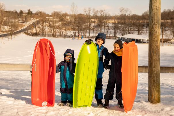 Boys Posing with Sleds in Snow