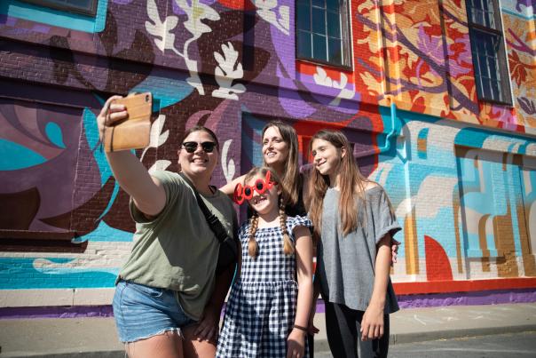 Women in Front of Wisdom Mural