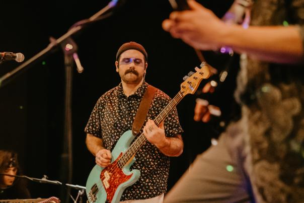 Man Playing Guitar in Band