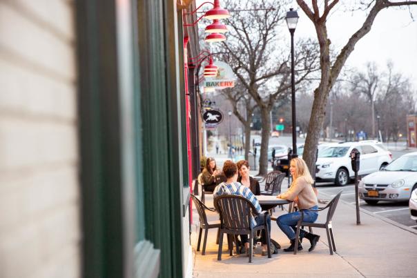 Three people at table outside restaurant